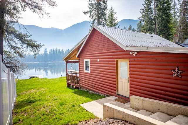 view of outdoor structure featuring a yard and a water and mountain view