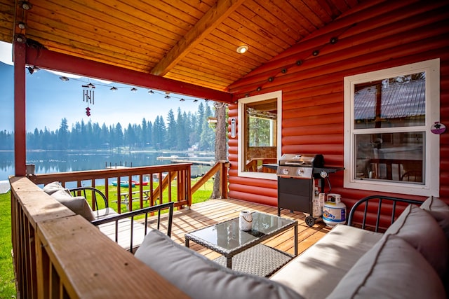 deck with area for grilling, a water view, and outdoor lounge area