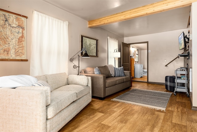 living room with beam ceiling and hardwood / wood-style flooring