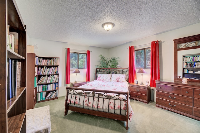 carpeted bedroom featuring a textured ceiling