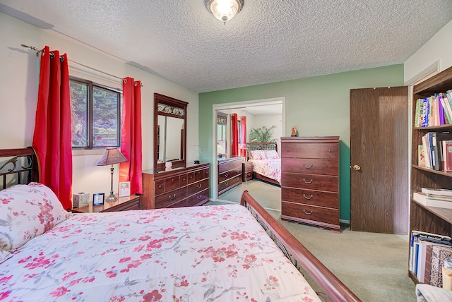 carpeted bedroom featuring a closet and a textured ceiling