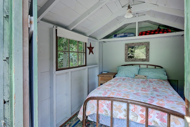 bedroom featuring vaulted ceiling with beams and wooden ceiling