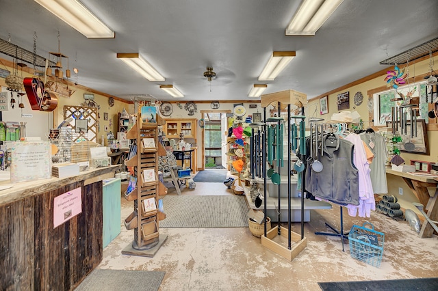 misc room featuring a wealth of natural light, ceiling fan, concrete floors, and a workshop area