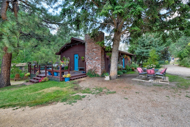 view of yard featuring a wooden deck and a patio