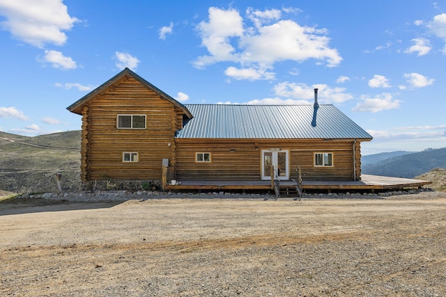 rear view of property featuring french doors and a mountain view