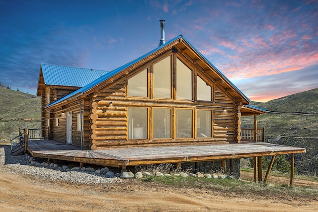 view of back house at dusk