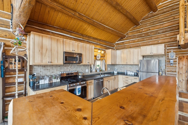 kitchen with backsplash, appliances with stainless steel finishes, vaulted ceiling with beams, and light brown cabinetry