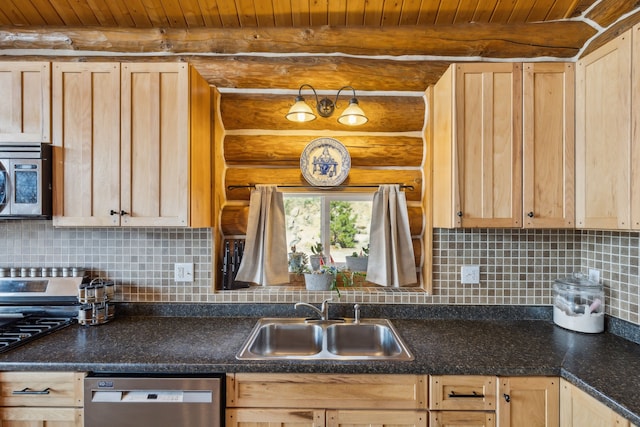 kitchen with stainless steel appliances, backsplash, light brown cabinetry, and sink