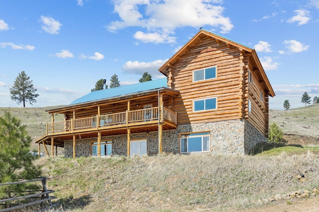 rear view of house featuring a deck