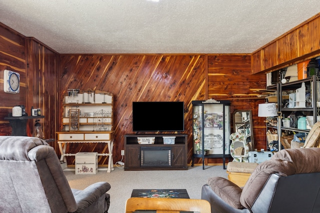 living room with carpet floors, a textured ceiling, and wooden walls