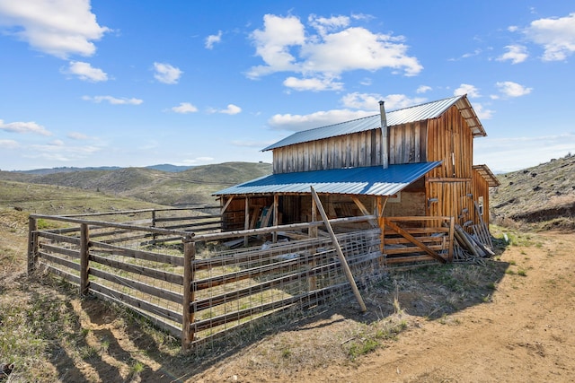 view of outbuilding with a mountain view and a rural view