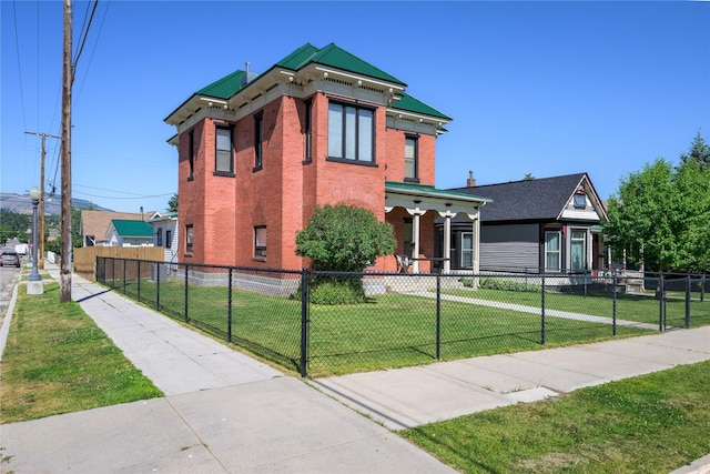 522 Hickory St, Anaconda, MT 59711 - view of front of home with a fenced front yard, brick siding, and a porch