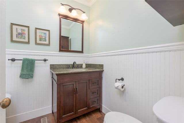 522 Hickory St, Anaconda, MT 59711 - half bath with wood finished floors, vanity, a wainscoted wall, and ornamental molding
