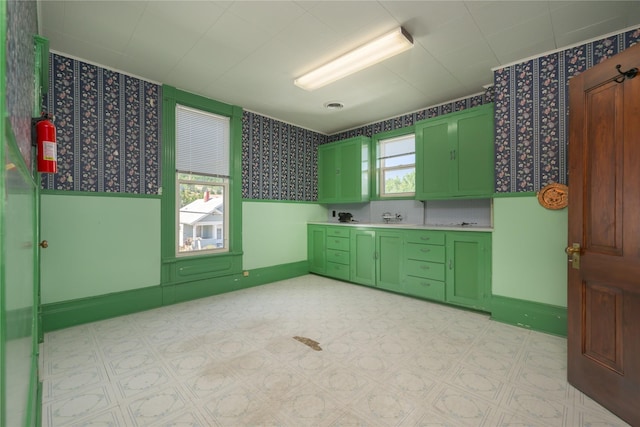 522 Hickory St, Anaconda, MT 59711 - kitchen featuring green cabinets, wallpapered walls, light countertops, and light floors