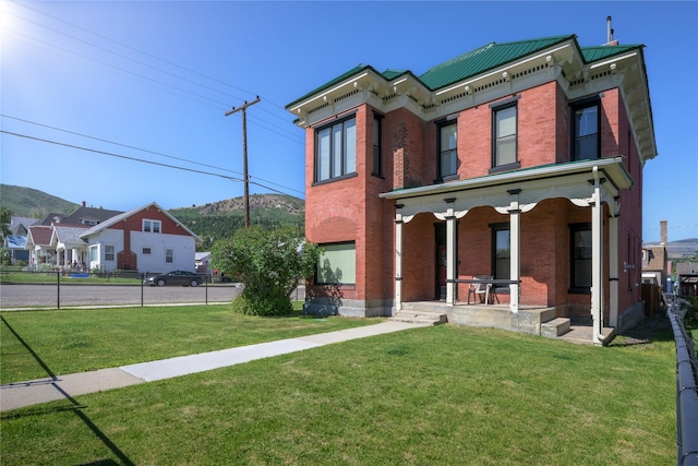 522 Hickory St, Anaconda, MT 59711 - view of front facade featuring brick siding, covered porch, and a mountain view