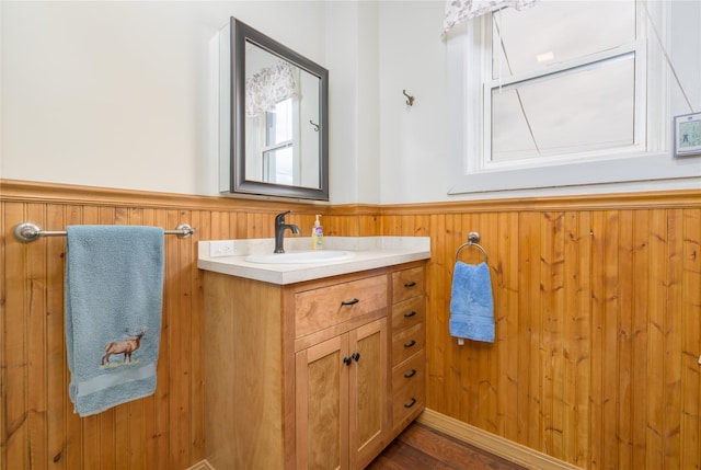 522 Hickory St, Anaconda, MT 59711 - bathroom featuring a wainscoted wall, vanity, wood finished floors, and wooden walls