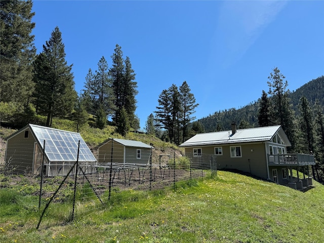 view of yard featuring an outdoor structure and a deck