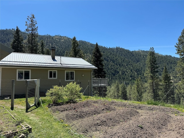 back of property featuring a mountain view