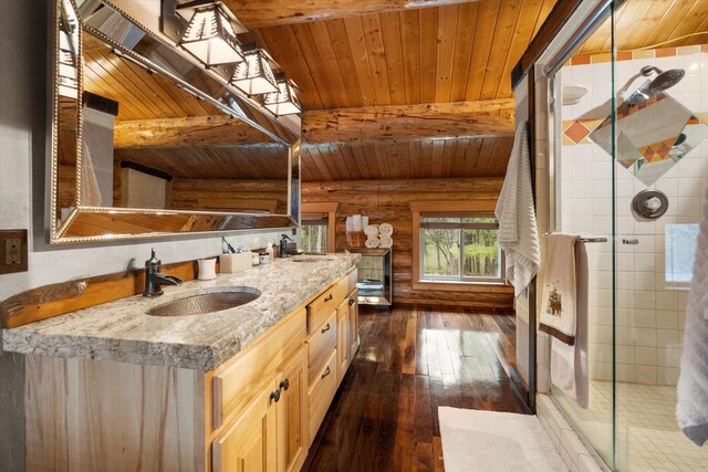 full bath with wooden ceiling, a sink, a stall shower, beamed ceiling, and rustic walls