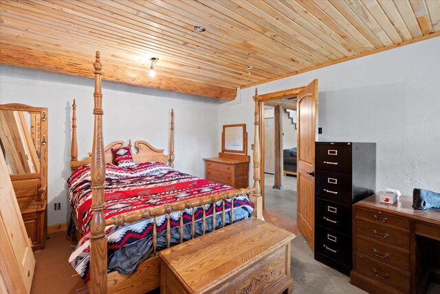 bedroom featuring concrete flooring and wooden ceiling