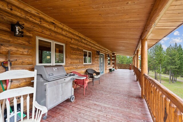 wooden deck featuring a view of trees