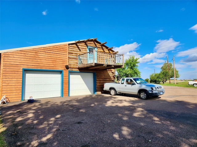 630 18th Rd NW, Choteau, MT 59422 - view of side of property with a garage, aphalt driveway, and a deck
