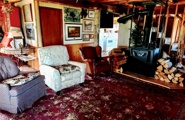 630 18th Rd NW, Choteau, MT 59422 - living area with wood walls, a wood stove, carpet, and washer / dryer