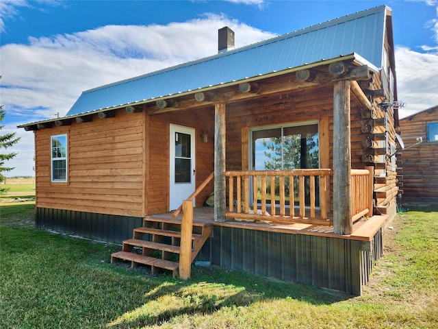 630 18th Rd NW, Choteau, MT 59422 - back of house with a chimney, metal roof, and a lawn