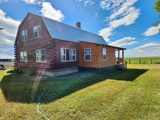 630 18th Rd NW, Choteau, MT 59422 - view of property exterior with a gambrel roof, a yard, log siding, metal roof, and a chimney