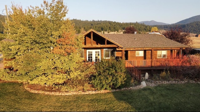102 W Clark St, Philipsburg, MT 59858 - view of front of property featuring stairway, a shingled roof, a front yard, and a deck with mountain view