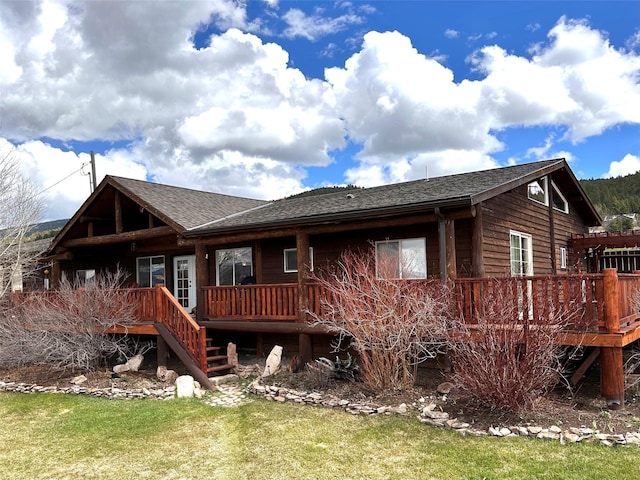 102 W Clark St, Philipsburg, MT 59858 - rear view of house featuring a wooden deck, a yard, and a shingled roof