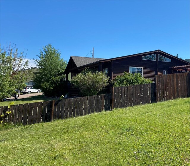 102 W Clark St, Philipsburg, MT 59858 - view of side of property featuring a lawn, fence, and a shingled roof