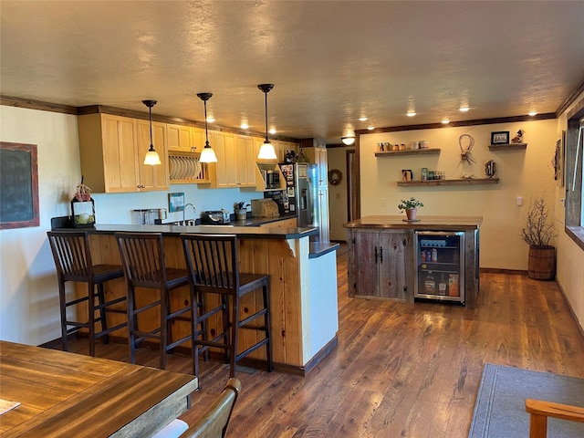 102 W Clark St, Philipsburg, MT 59858 - kitchen with wine cooler, dark countertops, a sink, crown molding, and a peninsula