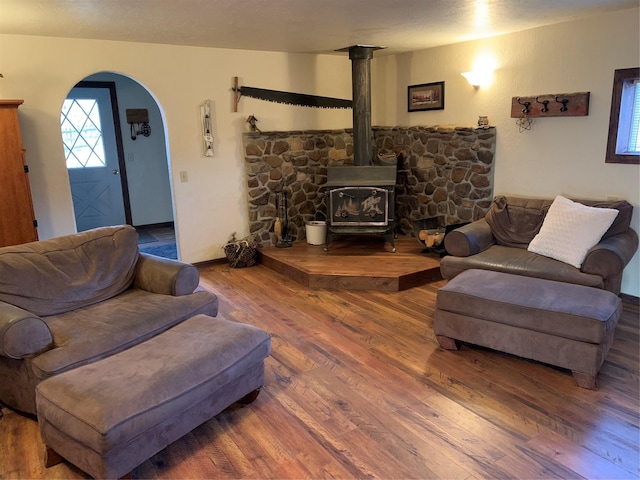 102 W Clark St, Philipsburg, MT 59858 - living area featuring arched walkways, wood finished floors, and a wood stove