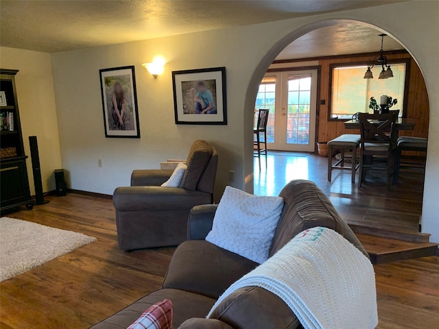 102 W Clark St, Philipsburg, MT 59858 - living room featuring baseboards, wood finished floors, and arched walkways