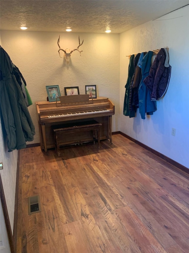 102 W Clark St, Philipsburg, MT 59858 - interior space featuring wood finished floors, visible vents, a textured wall, baseboards, and a textured ceiling