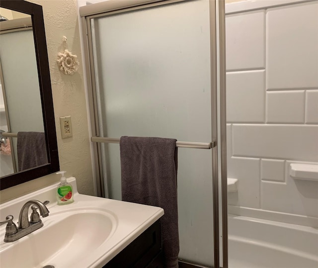 102 W Clark St, Philipsburg, MT 59858 - full bath with vanity, a textured wall, a shower with shower door, and a bathing tub