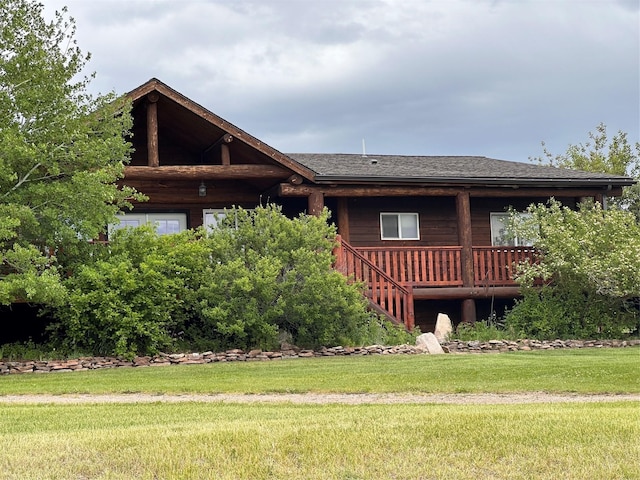 102 W Clark St, Philipsburg, MT 59858 - log-style house featuring stairway, a shingled roof, a front yard, and a deck