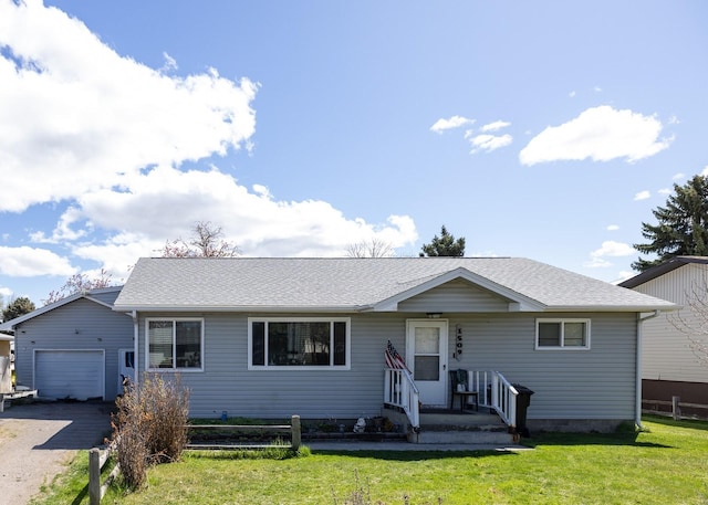 single story home with an outbuilding, a shingled roof, a front yard, fence, and a garage