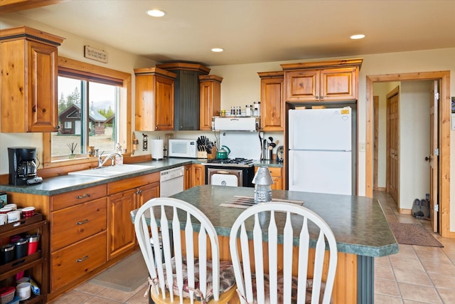 400 Kintla Ranch Rd, Polebridge, MT 59928 - kitchen featuring white appliances, dark countertops, recessed lighting, light tile patterned floors, and brown cabinets