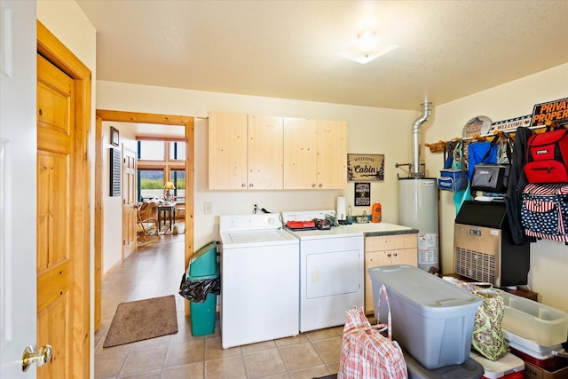400 Kintla Ranch Rd, Polebridge, MT 59928 - laundry area featuring water heater, washing machine and dryer, cabinet space, and light tile patterned flooring