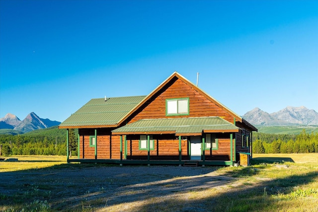 400 Kintla Ranch Rd, Polebridge, MT 59928 - view of front of property featuring a mountain view, a metal roof, and a porch