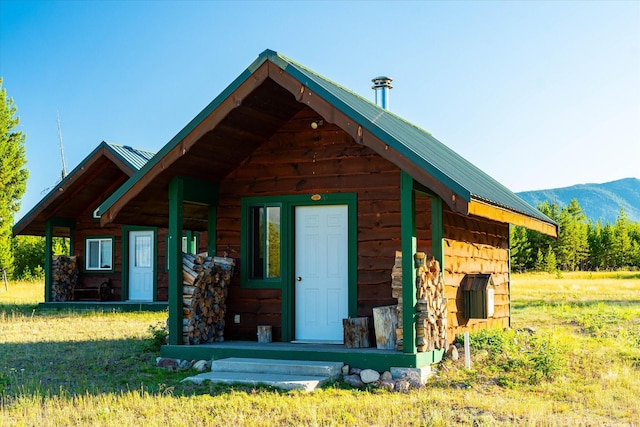 400 Kintla Ranch Rd, Polebridge, MT 59928 - view of front of home with a metal roof and a mountain view