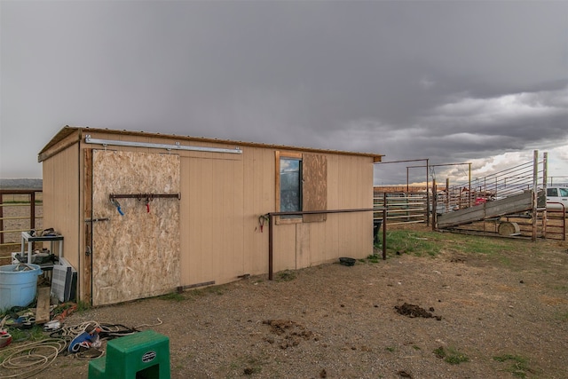 view of property exterior with an outbuilding