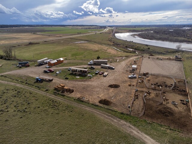 birds eye view of property with a water view and a rural view