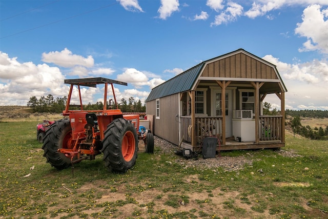 view of outdoor structure featuring cooling unit and a lawn