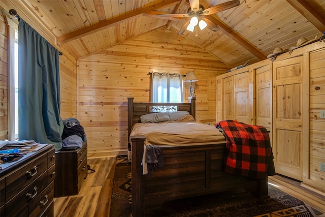 bedroom featuring vaulted ceiling with beams, hardwood / wood-style flooring, wooden walls, and wooden ceiling