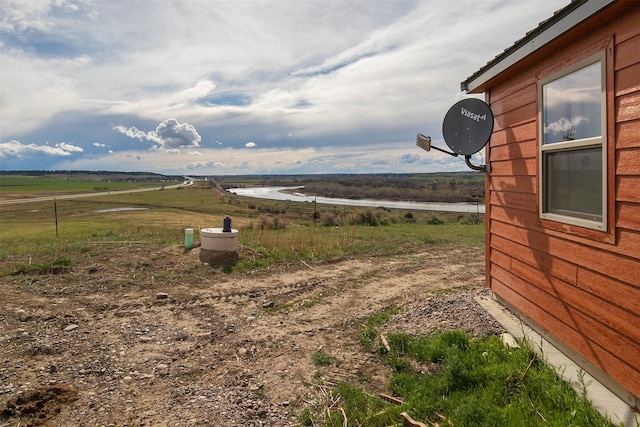 view of yard featuring a water view and a rural view