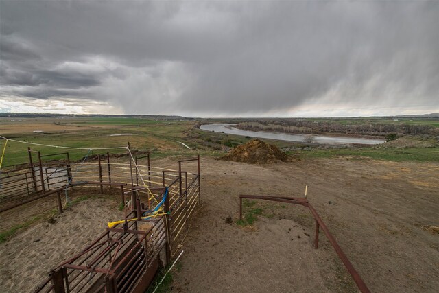 view of yard with a water view and a rural view