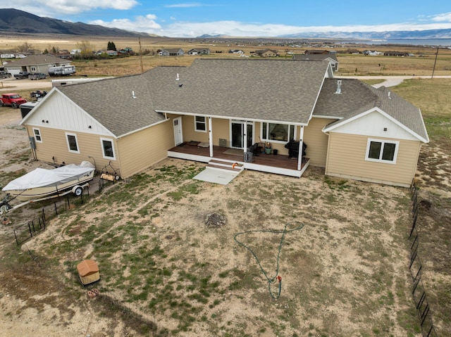 rear view of house featuring a deck with mountain view